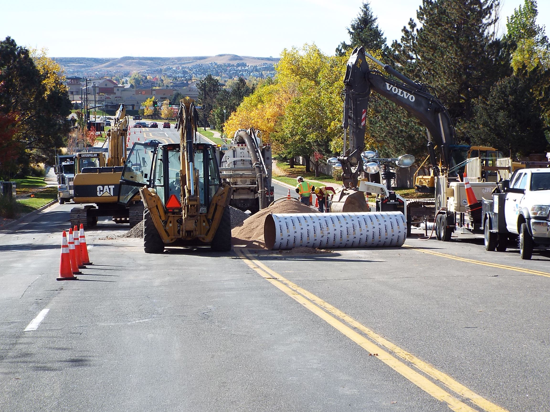 Backhoes and other large equipment doing construction on road